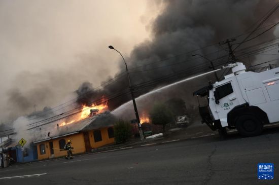 　　1月18日，消防员在智利比奥比奥大区彭科市救火。新华社发