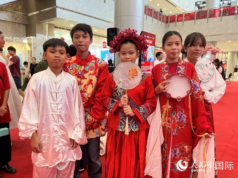 中国传统服饰体验区成为人气焦点,菲律宾民众纷纷试穿拍照。人民网记者 樊帆摄
